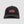 Black cap with Camel Trophy logo on a light gray background